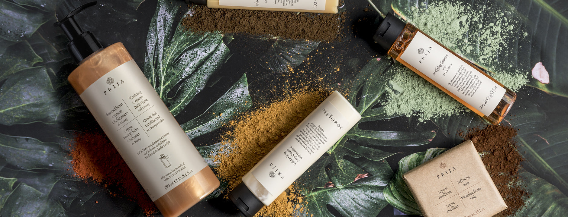 Prija bottles and soap among tropical leaves and spice powders
